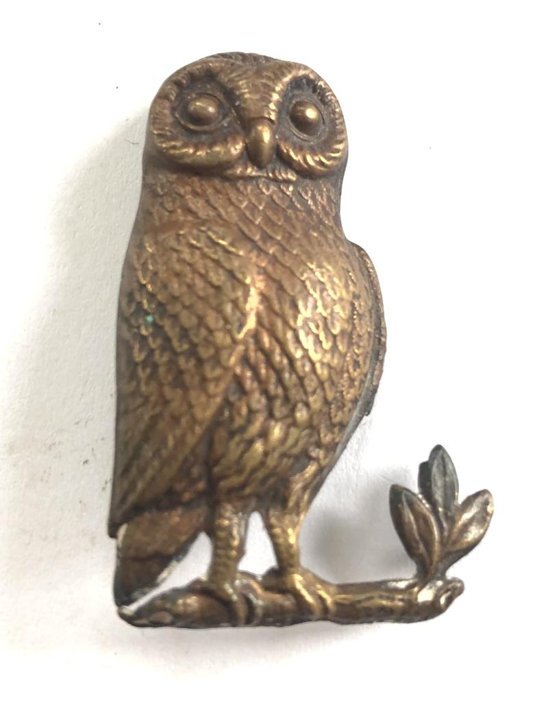 Manchester Grammar School OTC cap badge.